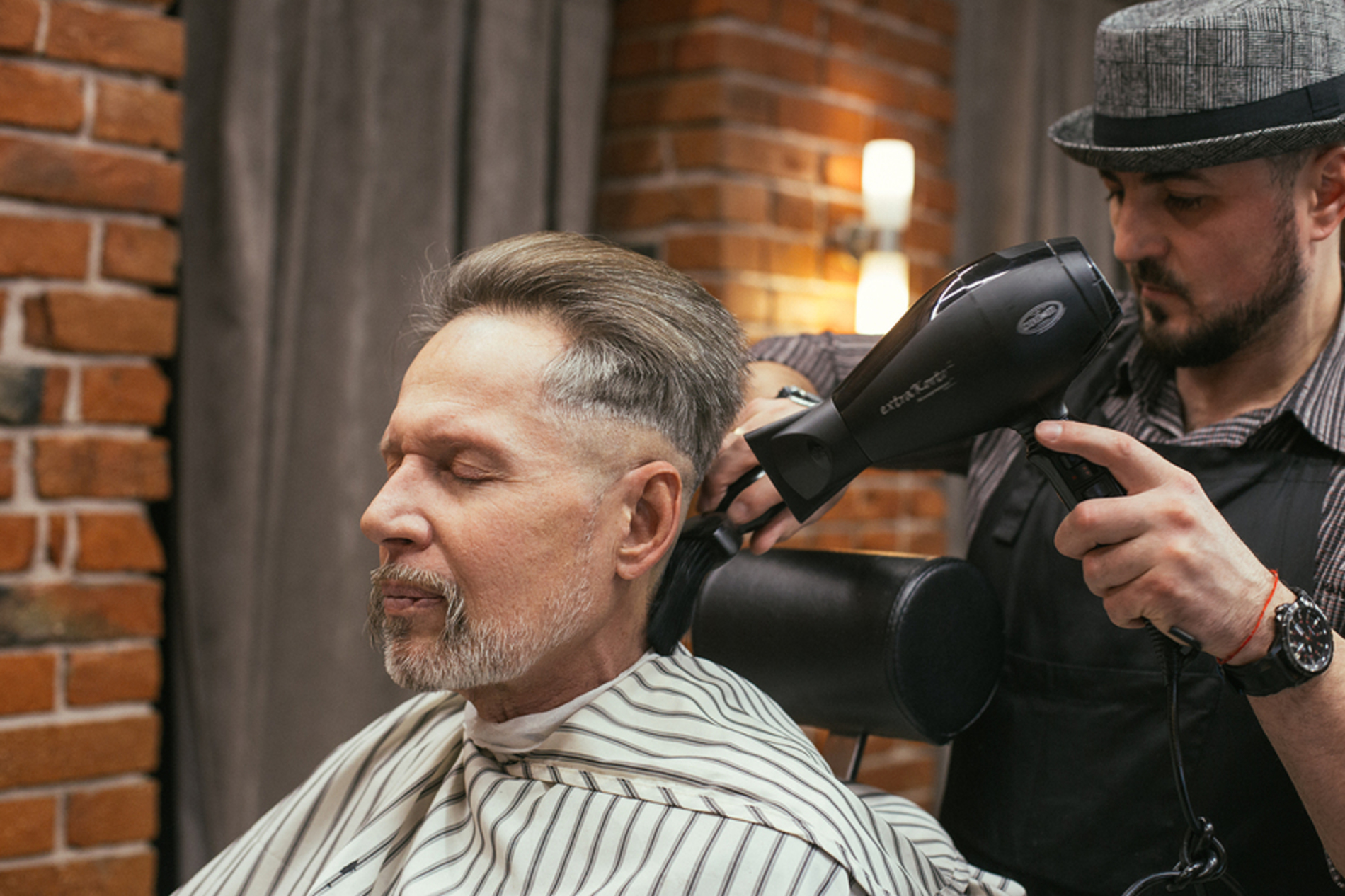 Man getting his hair cut at a barbers.